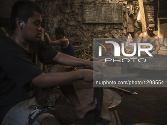 Workers forge gamelan in Gamelan Daliyo Legiyono, Pelem Lor Batu Retno Village, Banguntapan, Yogyakarta, Indonesia, on May 13, 2016. Gamelan...