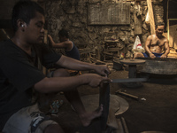 Workers forge gamelan in Gamelan Daliyo Legiyono, Pelem Lor Batu Retno Village, Banguntapan, Yogyakarta, Indonesia, on May 13, 2016. Gamelan...