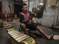 Legiyono (48) check sound of gamelan in Gamelan Daliyo Legiyono, Pelem Lor Batu Retno Village, Banguntapan, Yogyakarta, Indonesia, on May 13...