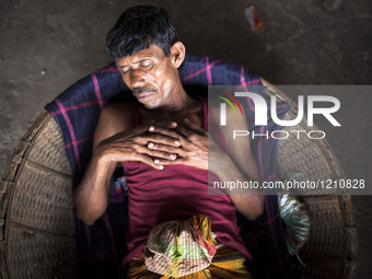 DHAKA, BANGLADESH - MAY 12: Labourers of Karwan Bazar break for a mid-day siesta to beat the hot summer noon in their workplace at Karwan Ba...