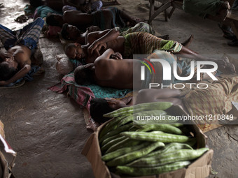 DHAKA, BANGLADESH - MAY 12: Labourers of Karwan Bazar break for a mid-day siesta to beat the hot summer noon in their workplace at Karwan Ba...