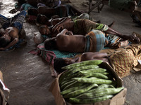 DHAKA, BANGLADESH - MAY 12: Labourers of Karwan Bazar break for a mid-day siesta to beat the hot summer noon in their workplace at Karwan Ba...