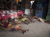 DHAKA, BANGLADESH - MAY 12: Labourers of Karwan Bazar break for a mid-day siesta to beat the hot summer noon in their workplace at Karwan Ba...