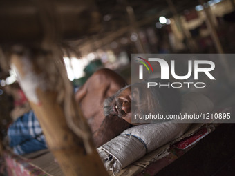 DHAKA, BANGLADESH - MAY 12: Labourers of Karwan Bazar break for a mid-day siesta to beat the hot summer noon in their workplace at Karwan Ba...