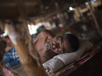 DHAKA, BANGLADESH - MAY 12: Labourers of Karwan Bazar break for a mid-day siesta to beat the hot summer noon in their workplace at Karwan Ba...