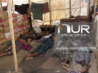 DHAKA, BANGLADESH - MAY 12: Labourers of Karwan Bazar break for a mid-day siesta to beat the hot summer noon in their workplace at Karwan Ba...