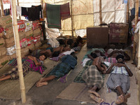 DHAKA, BANGLADESH - MAY 12: Labourers of Karwan Bazar break for a mid-day siesta to beat the hot summer noon in their workplace at Karwan Ba...