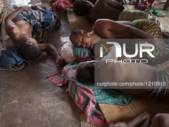 DHAKA, BANGLADESH - MAY 12: Labourers of Karwan Bazar break for a mid-day siesta to beat the hot summer noon in their workplace at Karwan Ba...