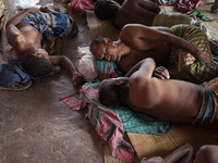 DHAKA, BANGLADESH - MAY 12: Labourers of Karwan Bazar break for a mid-day siesta to beat the hot summer noon in their workplace at Karwan Ba...