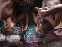 DHAKA, BANGLADESH - MAY 12: Labourers of Karwan Bazar break for a mid-day siesta to beat the hot summer noon in their workplace at Karwan Ba...