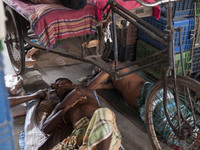 DHAKA, BANGLADESH - MAY 12: Labourers of Karwan Bazar break for a mid-day siesta to beat the hot summer noon in their workplace at Karwan Ba...