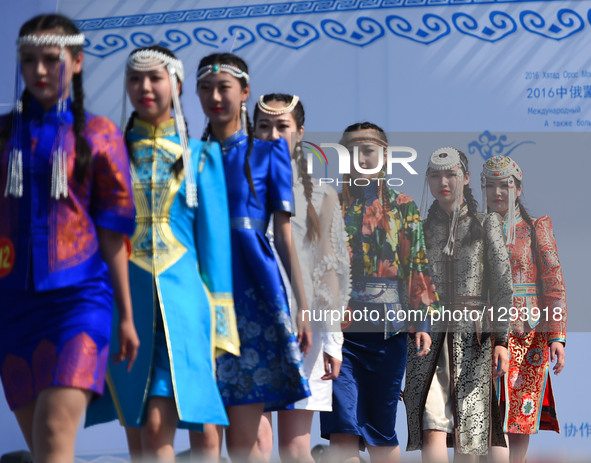 Models present costumes at Sino-Russian-Mongolian Costume Festival in Hulunbuir, north China's Inner Mongolia Autonomous Region, June 24, 20...