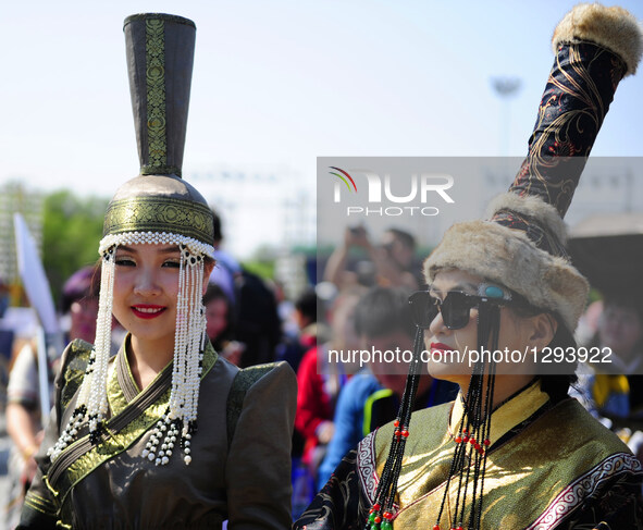 Models from Mongolia are seen at Sino-Russian-Mongolian Costume Festival in Hulunbuir, north China's Inner Mongolia Autonomous Region, June...