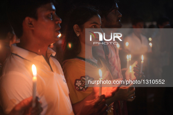 Bangladeshi social activists hold candles in memory of victims killed in an attack in Dhaka's diplomatic enclave Gulshan, Bangladesh, July 3...