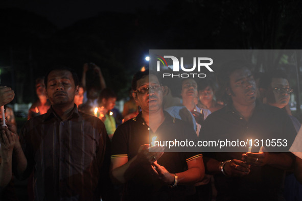 Bangladeshi social activists hold candles in memory of victims killed in an attack in Dhaka's diplomatic enclave Gulshan, Bangladesh, July 3...