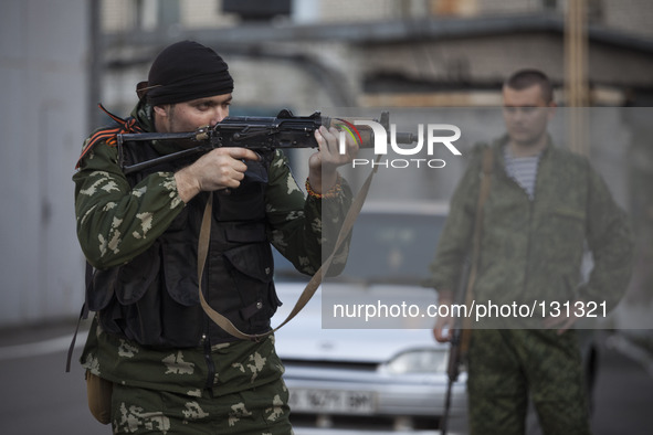 Militiamen from the Russian Orthodox Army undergo firearm training at the unit's headquarters in the occupied SBU building in Donetsk, easte...