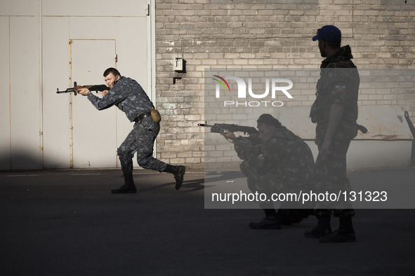 Militiamen from the Russian Orthodox Army undergo firearm training at the unit's headquarters in the occupied SBU building in Donetsk, easte...