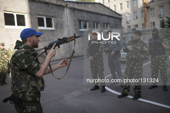 Militiamen from the Russian Orthodox Army undergo firearm training at the unit's headquarters in the occupied SBU building in Donetsk, easte...