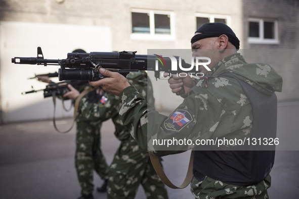 Militiamen from the Russian Orthodox Army undergo firearm training at the unit's headquarters in the occupied SBU building in Donetsk, easte...