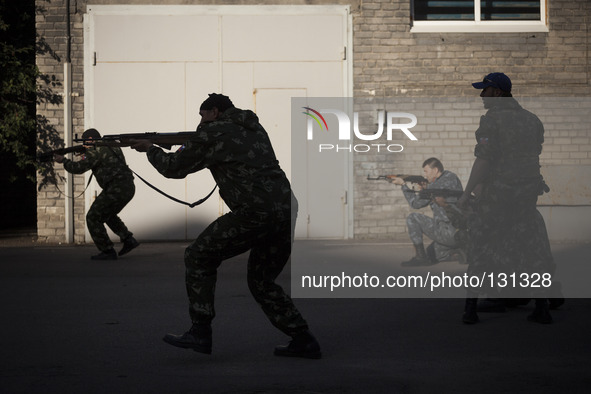 Militiamen from the Russian Orthodox Army undergo firearm training at the unit's headquarters in the occupied SBU building in Donetsk, easte...