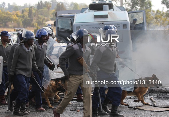 Police are deployed to quell disturbances during a protest in the impoverished suburb of Epworth on the outskirts of Harare, Zimbabwe, July...