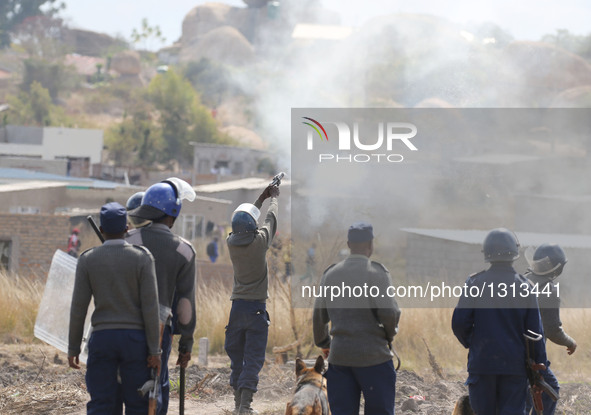 Police fire tear gas to protesters during a protest in the impoverished suburb of Epworth on the outskirts of Harare, Zimbabwe, July 4, 2016...