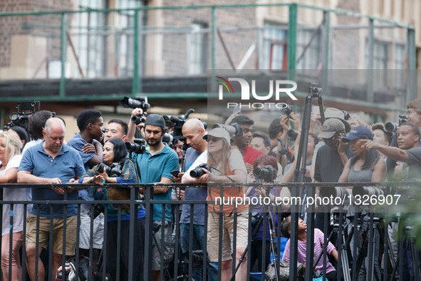 People wait to take photos of Manhattanhenge in Manhattan, New York, the United States, on July 11, 2016. The Manhattanhenge refers to the t...