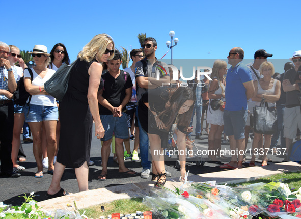 People gather to mourn victims of an attack in which a truck drove through crowds during Bastille Day celebrations in Nice, France on July 1...