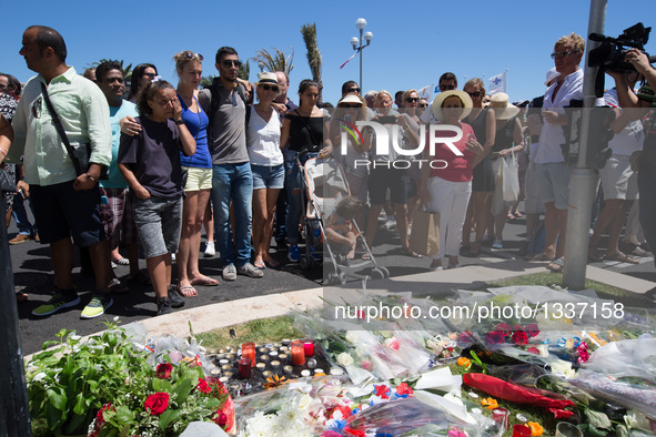 People gather to mourn victims of an attack in which a truck drove through crowds during Bastille Day celebrations in Nice, France on July 1...