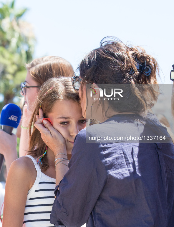 People comfort each other near the site of the terrorist attack in Nice, France, July 15, 2016. The death toll rises to 84 from an attack in...