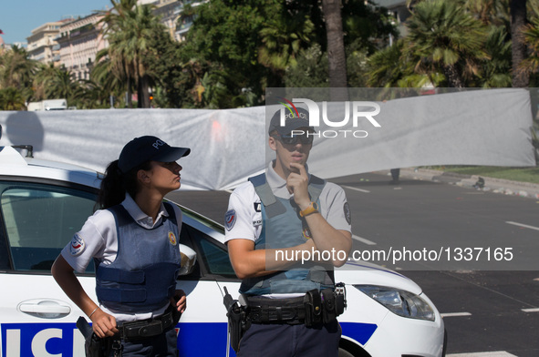 Two police officers stand guard near the site of the terrorist attack in Nice, France, July 15, 2016. The death toll rises to 84 from an att...