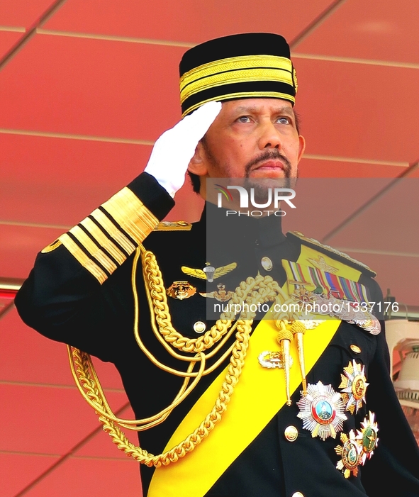 Brunei's Sultan Haji Hassanal Bolkiah salutes to the honor guard during a ceremony to celebrate his 70th birthday in Bandar Seri Begawan, Br...