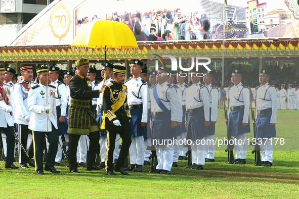 Brunei's Sultan Haji Hassanal Bolkiah (R, front) inspects the honor guard during a ceremony to celebrate his 70th birthday in Bandar Seri Be...