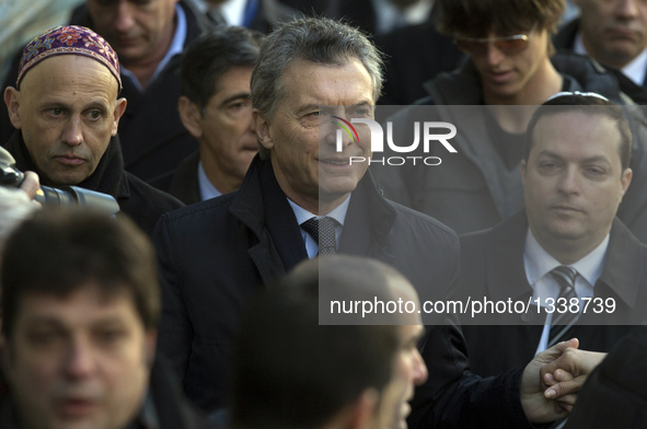 Argentine President Mauricio Macri (C) participates in a commemoration of the 22nd anniversary of a terrorist attack on a Jewish center in 1...