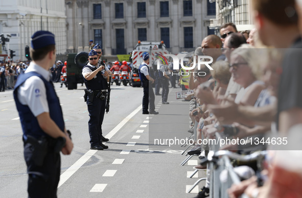 Police guard on an avenue as visitors wait for the Military Parade to celebrate Belgium's National Day in Brussels, Belgium, July 21, 2016.