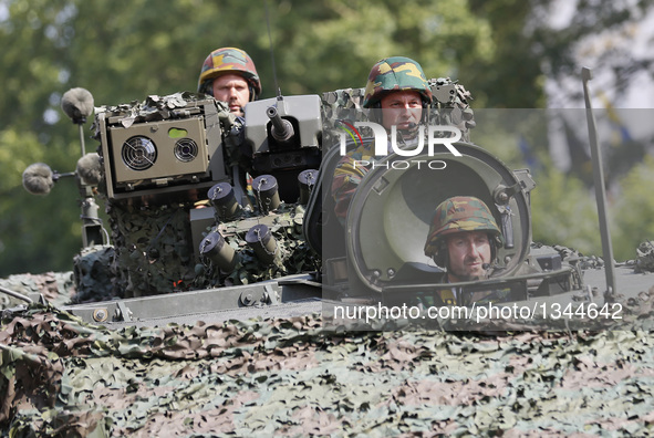 An armed vehicle passes by during the Military Parade to celebrate Belgium's National Day in Brussels, Belgium, July 21, 2016.