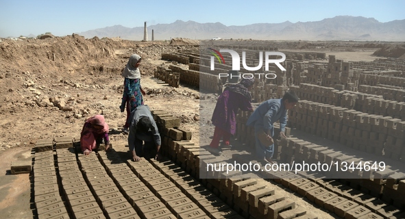 Afghan children work at a brick factory in Kabul, capital of Afghanistan, July 21, 2016. Some 1.3 million school-aged Afghan children are de...