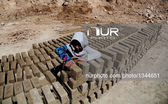 An Afghan child works at a brick factory in Kabul, capital of Afghanistan, July 21, 2016. Some 1.3 million school-aged Afghan children are d...