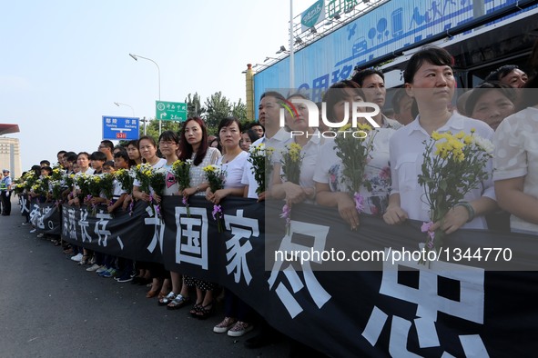 People wait for the hearses carrying the coffins of Chinese UN peacekeepers killed in the recent fighting in the conflict-hit South Sudan in...