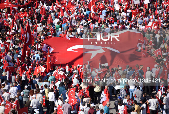 People attend a rally at Istanbul's Taksim square in Turkey, on July 24, 2016. Tens of thousands of Turks on Sunday flocked to a rally in Is...