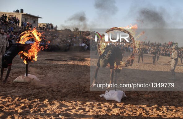 Palestinians show their skills during a military graduation ceremony as part of a military-style summer camp organized by Hamas's armed wing...