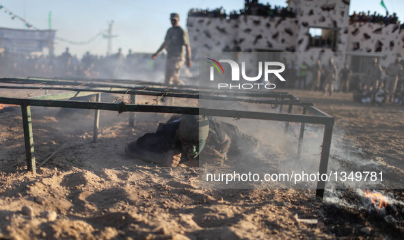 A Palestinian shows his skills during a military graduation ceremony as part of a military-style summer camp organized by Hamas's armed wing...