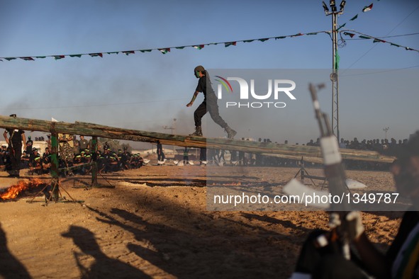 A Palestinian shows his skills during a military graduation ceremony as part of a military-style summer camp organized by Hamas's armed wing...