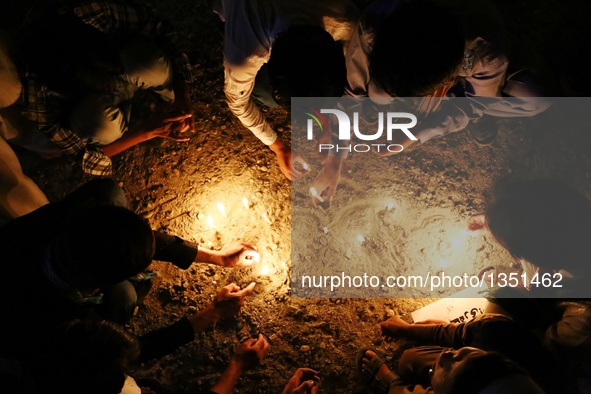 People attend a candlelight vigil to commemorate victims of Kabul twin bomb attack in Ghazni province, Afghanistan, July 24, 2016. In total...