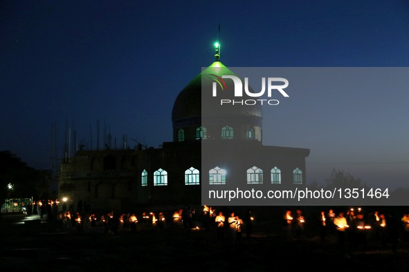 People attend a candlelight vigil to commemorate victims of Kabul twin bomb attack in Herat province, Afghanistan, July 24, 2016. In total 8...