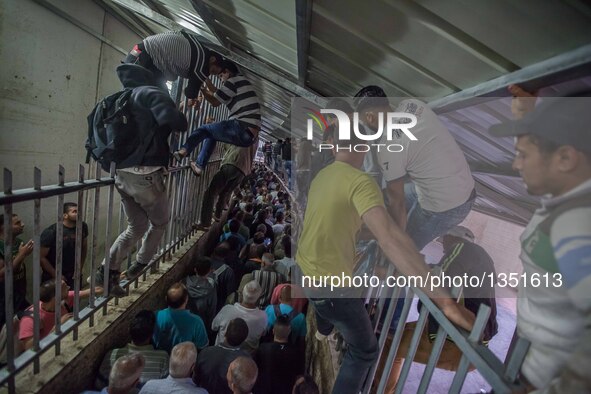 Palestinian labourers, working in Israel, make their way to their workplaces, through the main Israeli terminal in the West Bank city of Bet...