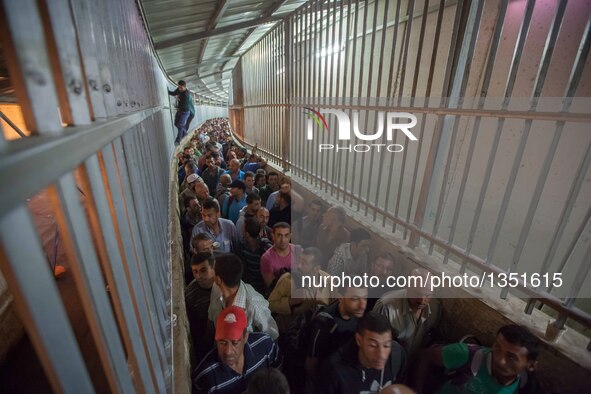 Palestinian labourers, working in Israel, make their way to their workplaces, through the main Israeli terminal in the West Bank city of Bet...