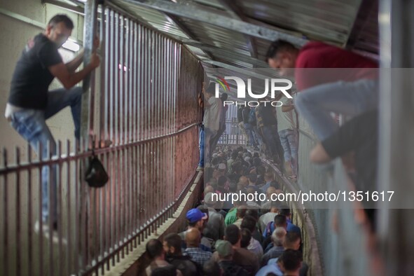 Palestinian labourers, working in Israel, make their way to their workplaces, through the main Israeli terminal in the West Bank city of Bet...