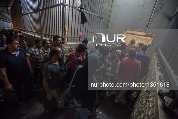 Palestinian labourers, working in Israel, make their way to their workplaces, through the main Israeli terminal in the West Bank city of Bet...