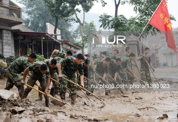 Soldiers clean up streets in Jingxing County, north China's Hebei Province, July 29, 2016. A total of 2,400 soldiers have been dispatched to...